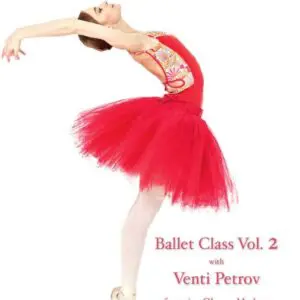 Ballet dancer in a vibrant red tutu gracefully poses on stage.