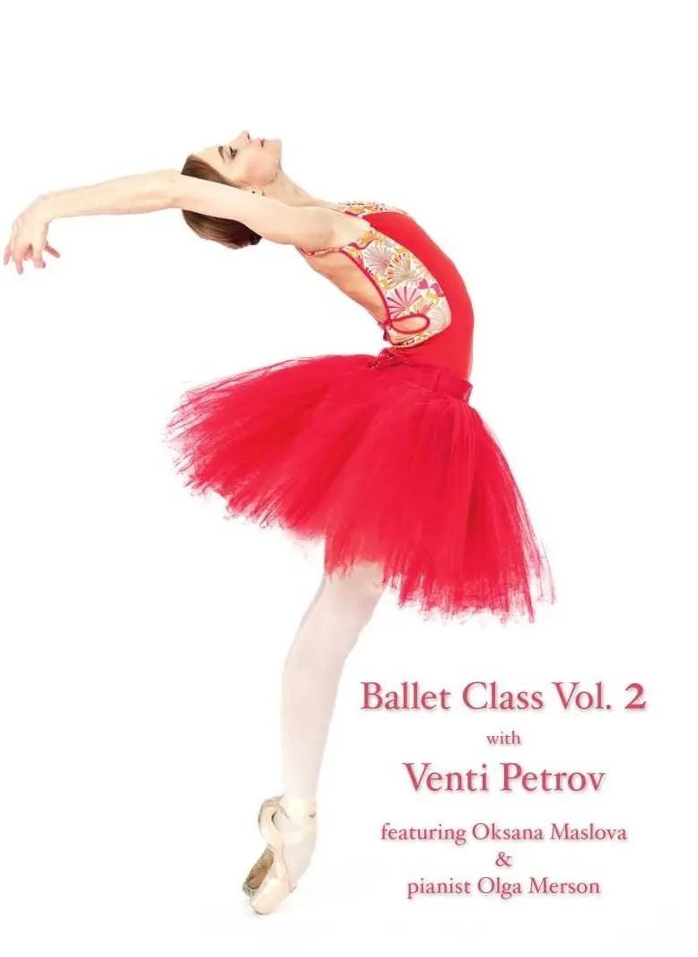 Ballet dancer in a vibrant red tutu gracefully poses on stage.