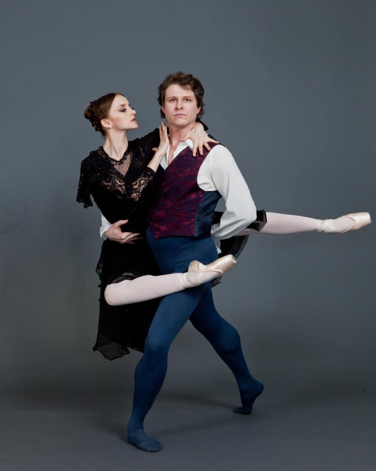 Two ballet dancers performing an elegant pose.